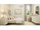 Bright bedroom with neutral tones, a large window with curtains, and stylish decor for a cozy feel at 25162 N 177Th Dr, Surprise, AZ 85387