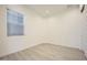 Neutral bedroom with a window, tile flooring and white walls offers a minimalist aesthetic at 25162 N 177Th Dr, Surprise, AZ 85387