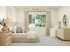 Serene bedroom featuring a plush bed, soft lighting, and a view of the outdoors at 25162 N 177Th Dr, Surprise, AZ 85387