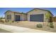 Lovely single-story home featuring a brick driveway, two car garage, and well-maintained desert landscaping at 25162 N 177Th Dr, Surprise, AZ 85387