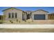 Charming single-story home with a well-manicured front yard, desert landscaping and a two car garage at 25162 N 177Th Dr, Surprise, AZ 85387