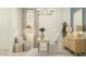 Stylish home office featuring modern lighting, comfortable seating, and ample desk space at 25162 N 177Th Dr, Surprise, AZ 85387