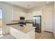 Modern kitchen featuring white cabinetry, stainless steel appliances, and a functional island at 25162 N 177Th Dr, Surprise, AZ 85387
