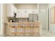 Modern kitchen featuring white cabinets, stainless steel appliances, and a breakfast bar with seating at 25162 N 177Th Dr, Surprise, AZ 85387