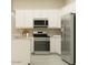 Bright kitchen featuring stainless steel appliances, white cabinetry, and modern fixtures at 25162 N 177Th Dr, Surprise, AZ 85387