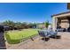 Backyard featuring a putting green, patio seating, and a well-maintained outdoor space at 2531 W Saint Catherine Ave, Phoenix, AZ 85041