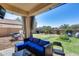 Cozy outdoor living space featuring a covered patio, putting green, and manicured backyard at 2531 W Saint Catherine Ave, Phoenix, AZ 85041