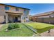 Spacious backyard with a covered patio, artificial turf putting green, and desert landscaping at 2531 W Saint Catherine Ave, Phoenix, AZ 85041