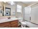 Bathroom with a single sink vanity, tiled floor, and a shower over bath with sliding glass door at 2531 W Saint Catherine Ave, Phoenix, AZ 85041