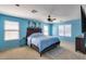 Bedroom with large bed, ceiling fan, carpet floors, and natural lighting from two windows at 2531 W Saint Catherine Ave, Phoenix, AZ 85041