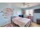 Bright bedroom features a whimsical wall decal, ceiling fan, and natural light from the window at 2531 W Saint Catherine Ave, Phoenix, AZ 85041