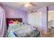 Bedroom with purple walls featuring a decorated bed, closet, and window at 2531 W Saint Catherine Ave, Phoenix, AZ 85041