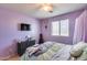 Cozy bedroom with purple walls, decorated bed, and dresser at 2531 W Saint Catherine Ave, Phoenix, AZ 85041