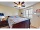 Bedroom featuring a ceiling fan, carpet flooring, and a window for natural light at 2531 W Saint Catherine Ave, Phoenix, AZ 85041