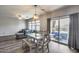 Bright dining area with wood floors, stylish light fixture and view of the backyard at 2531 W Saint Catherine Ave, Phoenix, AZ 85041
