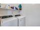 Laundry room with front-load washer and dryer and upper shelf storage at 2531 W Saint Catherine Ave, Phoenix, AZ 85041
