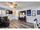 Open-concept living room with wood-look floors and fan at 2531 W Saint Catherine Ave, Phoenix, AZ 85041