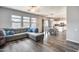 Open floor plan showcasing a living room with gray sofa, dining area, and kitchen with modern appliances at 2531 W Saint Catherine Ave, Phoenix, AZ 85041