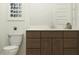 Bright bathroom featuring a modern vanity with drawers, a toilet, a framed art piece, and a mirror at 25437 N 176Th Ave, Surprise, AZ 85387