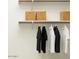 Closet features white shelves, hanging rods with clothes, and woven baskets for storage at 25437 N 176Th Ave, Surprise, AZ 85387