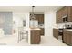 A kitchen with stainless steel appliances, granite countertops, a large island, and modern lighting at 25437 N 176Th Ave, Surprise, AZ 85387