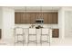 A well-lit kitchen featuring stainless steel appliances, a large island with seating, and ample storage at 25437 N 176Th Ave, Surprise, AZ 85387