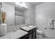 Bright bathroom with marble counters, large mirror, single sink and decorative elements create a clean, functional space at 2704 S 172Nd Ln, Goodyear, AZ 85338