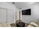 Cozy bedroom featuring a modern flat screen tv, closet, and wood-look flooring at 2704 S 172Nd Ln, Goodyear, AZ 85338