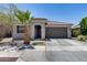 Charming single-story home featuring a low-maintenance front yard, desert landscaping, and a two-car garage at 2704 S 172Nd Ln, Goodyear, AZ 85338