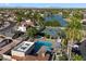 Stunning aerial view of community amenities, including a pool, tennis court, and access to a beautiful lake at 2726 W Meseto Cir, Mesa, AZ 85202