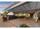 Inviting backyard patio with comfortable seating, hot tub, and shade covering at 2726 W Meseto Cir, Mesa, AZ 85202