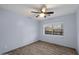 Cozy bedroom featuring wood-look flooring, a ceiling fan, and natural light at 2726 W Meseto Cir, Mesa, AZ 85202