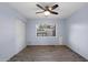 Bright bedroom featuring vinyl floors, ceiling fan, and natural light from the window at 2726 W Meseto Cir, Mesa, AZ 85202