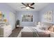 Bedroom featuring wood-look floors and a large window at 2726 W Meseto Cir, Mesa, AZ 85202