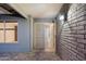 Welcoming covered entryway with brick accents and decorative security door at 2726 W Meseto Cir, Mesa, AZ 85202