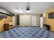 Spacious garage featuring checkerboard flooring, storage cabinets, and work table at 2726 W Meseto Cir, Mesa, AZ 85202