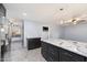 A kitchen with granite countertops, stainless steel refrigerator, and dark cabinets at 2726 W Meseto Cir, Mesa, AZ 85202