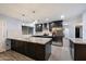Modern kitchen with granite countertops, stainless steel appliances, and dark wood cabinets at 2726 W Meseto Cir, Mesa, AZ 85202