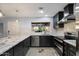Updated kitchen with stainless steel appliances, granite counters, subway tile, and modern lighting at 2726 W Meseto Cir, Mesa, AZ 85202