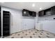 Laundry room with tile floor, cabinets, utility sink and shelving at 2726 W Meseto Cir, Mesa, AZ 85202