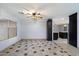 Open-concept living room with tiled flooring, a ceiling fan, and bright lighting at 2726 W Meseto Cir, Mesa, AZ 85202