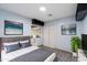 Well appointed bedroom with modern decor, wood-look flooring, TV, art, and closet at 2726 W Meseto Cir, Mesa, AZ 85202