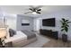 Bedroom with a large bed, TV, sleek dresser, and plant accents at 2726 W Meseto Cir, Mesa, AZ 85202