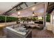 Relaxing outdoor patio with comfortable seating, fans, and landscape views at 2726 W Meseto Cir, Mesa, AZ 85202