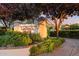 Community sign for Laguna Park with manicured landscaping and surrounding greenery at 2726 W Meseto Cir, Mesa, AZ 85202