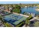 Aerial view of tennis courts near a lake with boat docks and residential area at 2726 W Meseto Cir, Mesa, AZ 85202