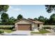 Charming single-story home with a two-car garage, lush landscaping, and inviting curb appeal at 32002 N Pony Express Rd, San Tan Valley, AZ 85143