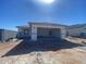 Single-story home featuring an attached two-car garage under a blue sky at 32002 N Pony Express Rd, San Tan Valley, AZ 85143