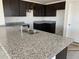 Bright kitchen featuring dark cabinets and granite countertops at 32002 N Pony Express Rd, San Tan Valley, AZ 85143