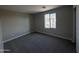 Bright bedroom with plush carpeting and ample natural light from a large window at 3363 S 180Th Ln, Goodyear, AZ 85338